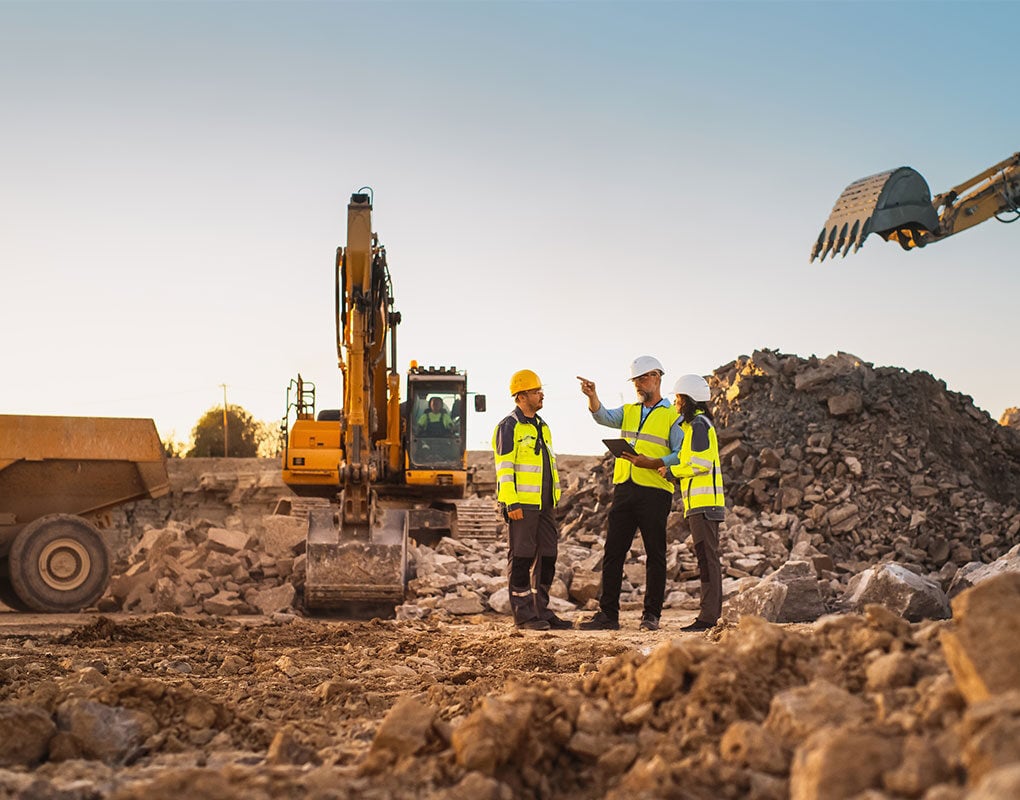 Construction workers discussing next steps at a worksite